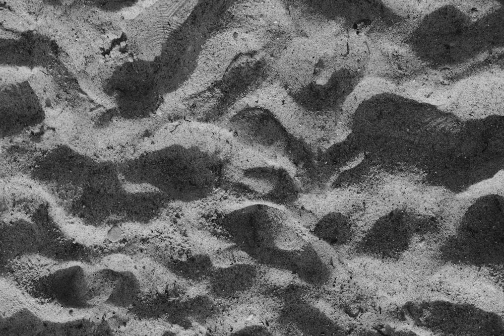 a black and white photo of rocks and sand