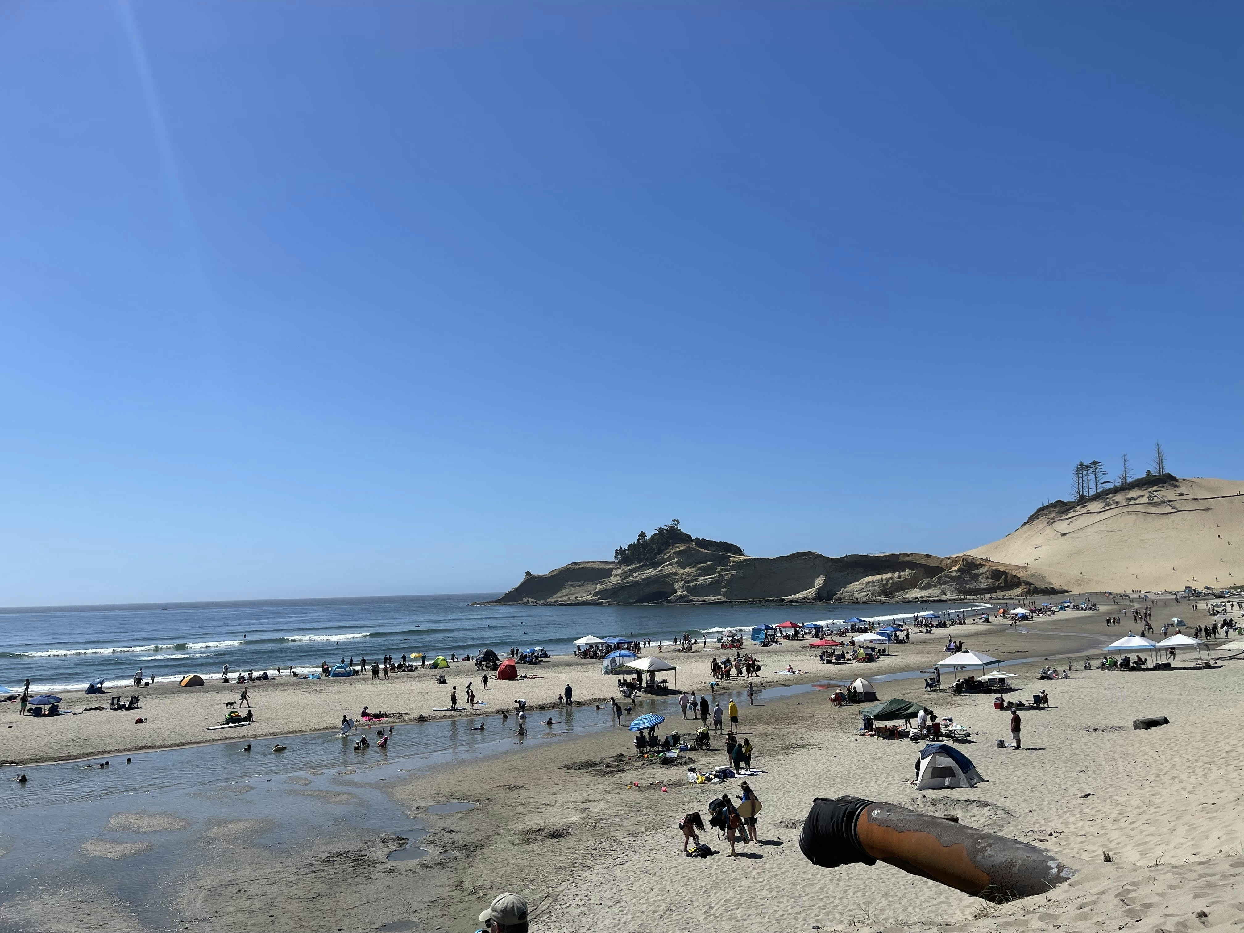 a crowded beach with lots of people on it