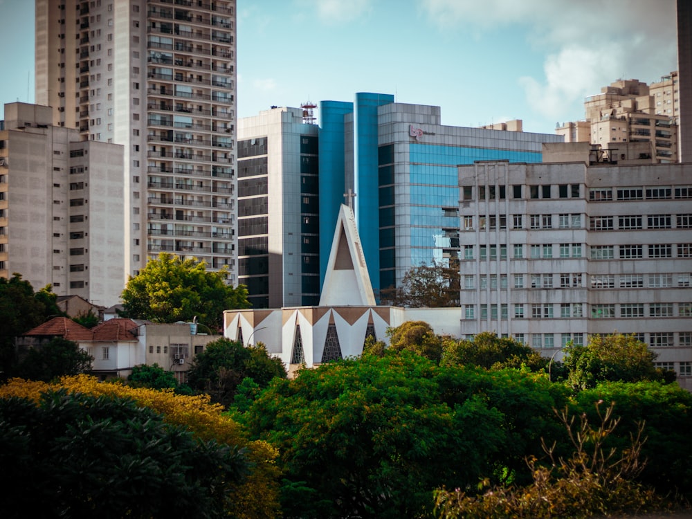 a church in the middle of a city with tall buildings in the background
