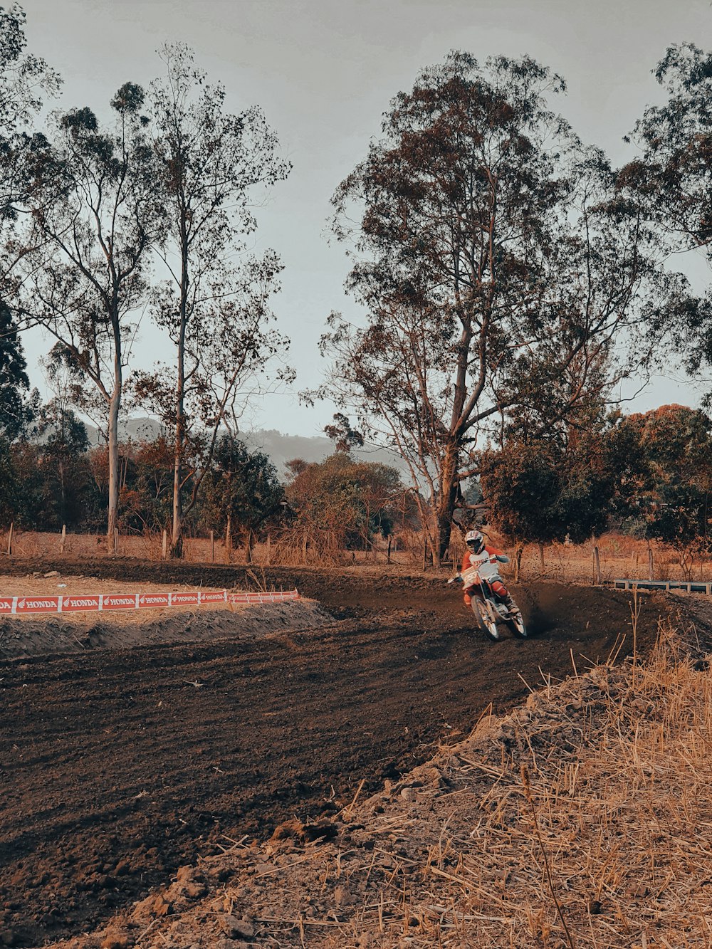 a person riding a dirt bike on a dirt track