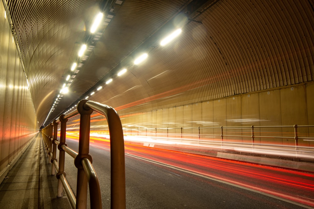 a long exposure photo of a tunnel at night