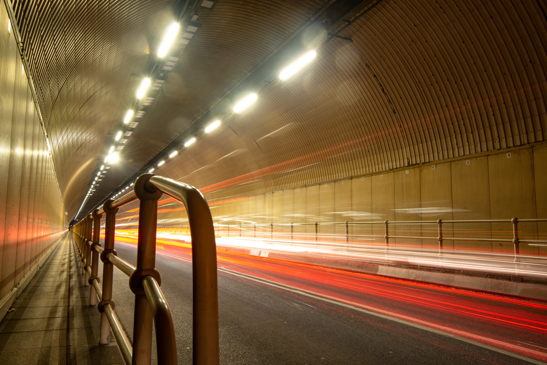 a long exposure photo of a tunnel at night