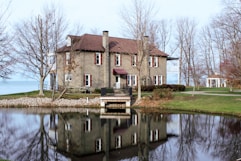 a large house sitting next to a body of water