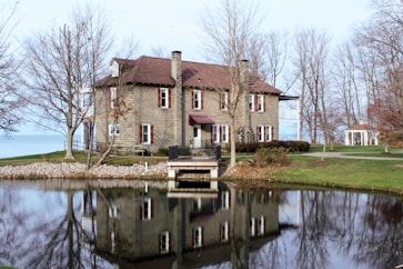 a large house sitting next to a body of water