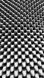 A textured surface with an intricate pattern of uniform, raised bumps and grooves, creating a three-dimensional effect.