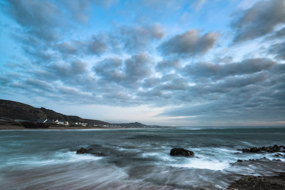 a view of the ocean with a cloudy sky