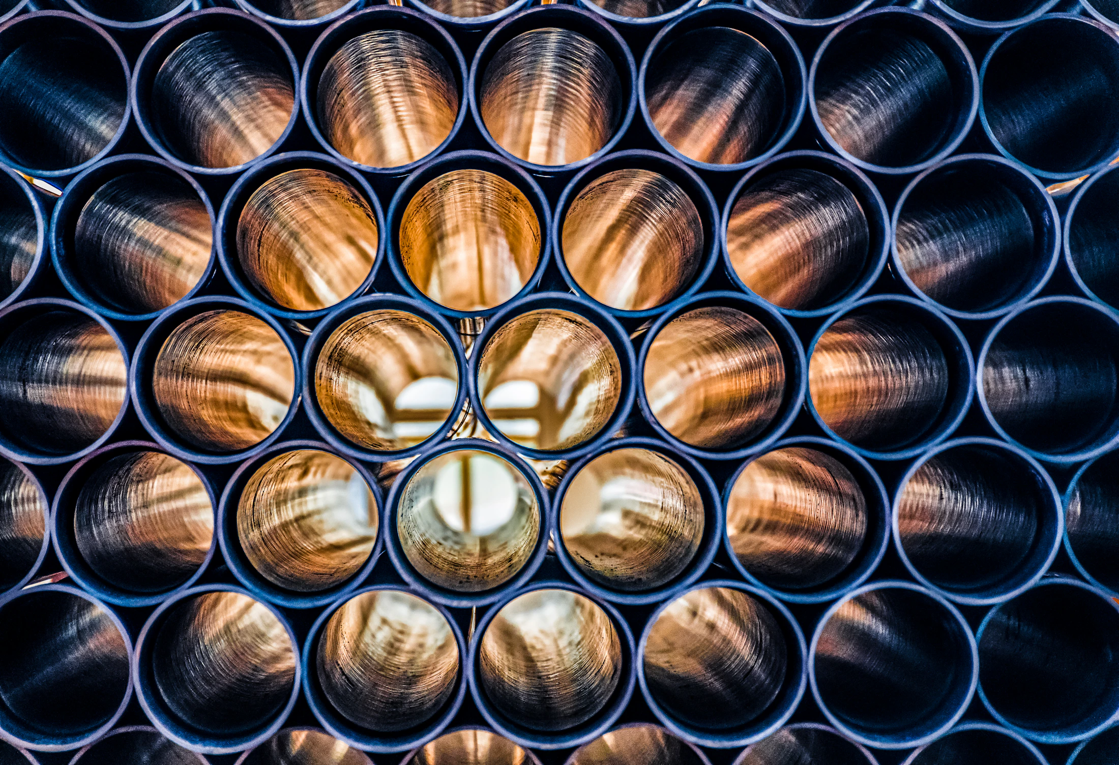 Bundle of large round steel pipes with hollow ends clearly visible