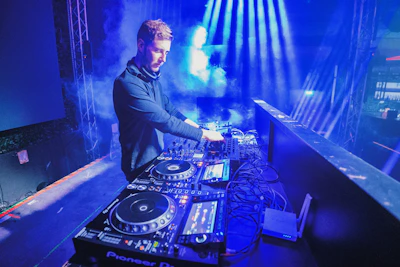 a dj mixing music in a dark room