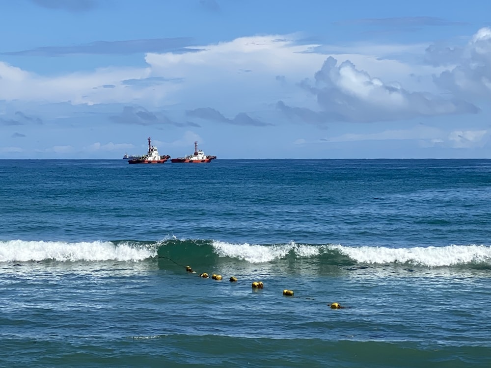 a large cargo ship in the ocean near a wave