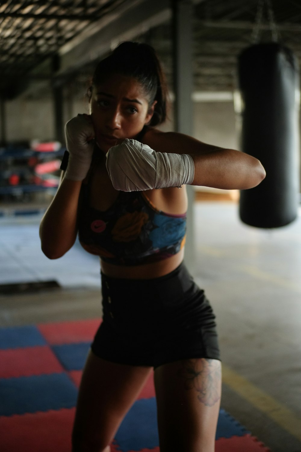 a woman in a boxing ring with a punching glove