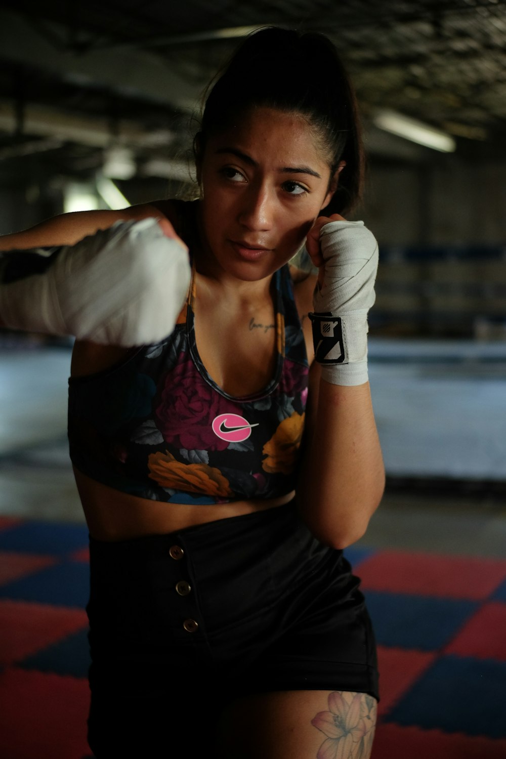 a woman in a sports bra top and boxing gloves