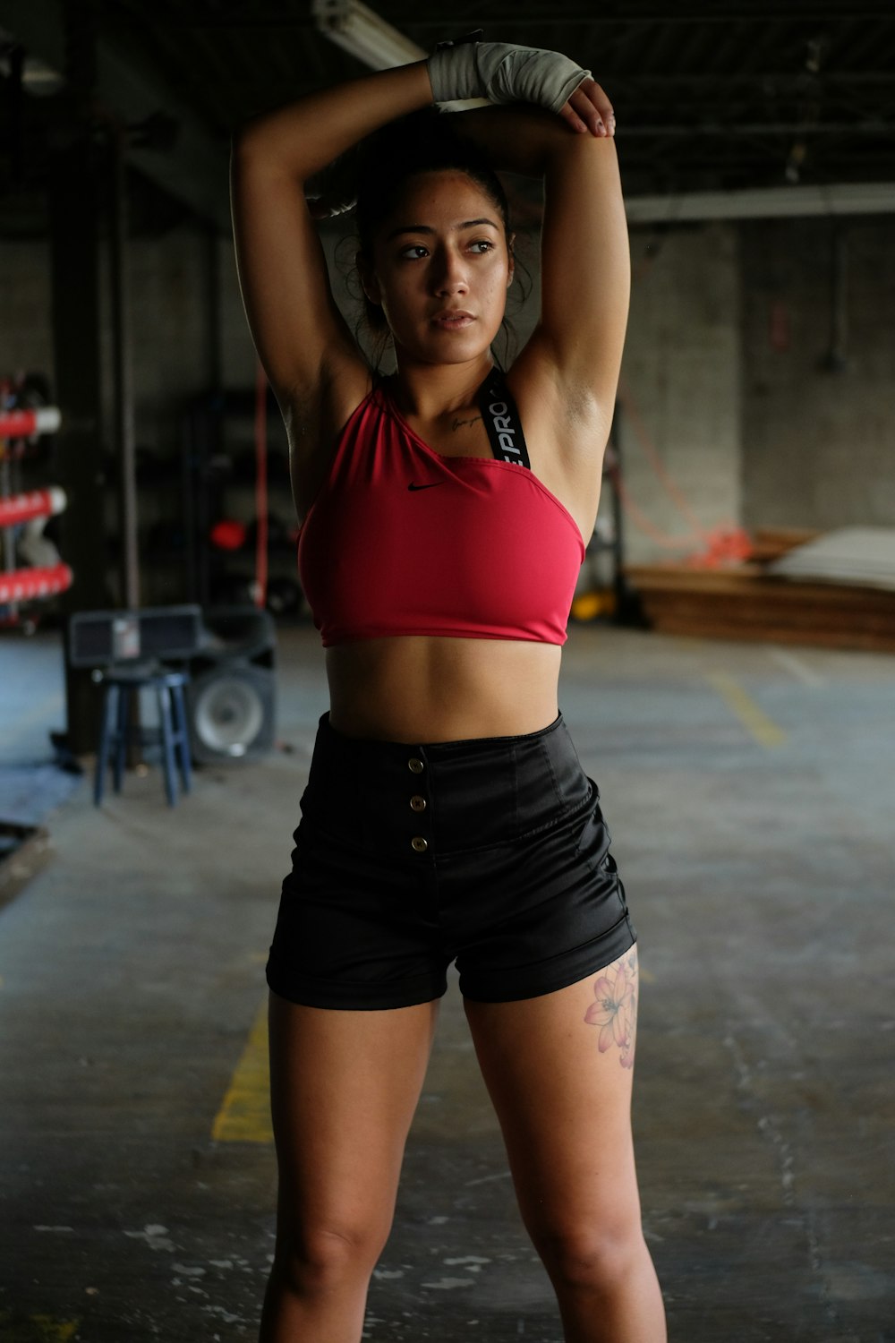 a woman in a red top and black shorts