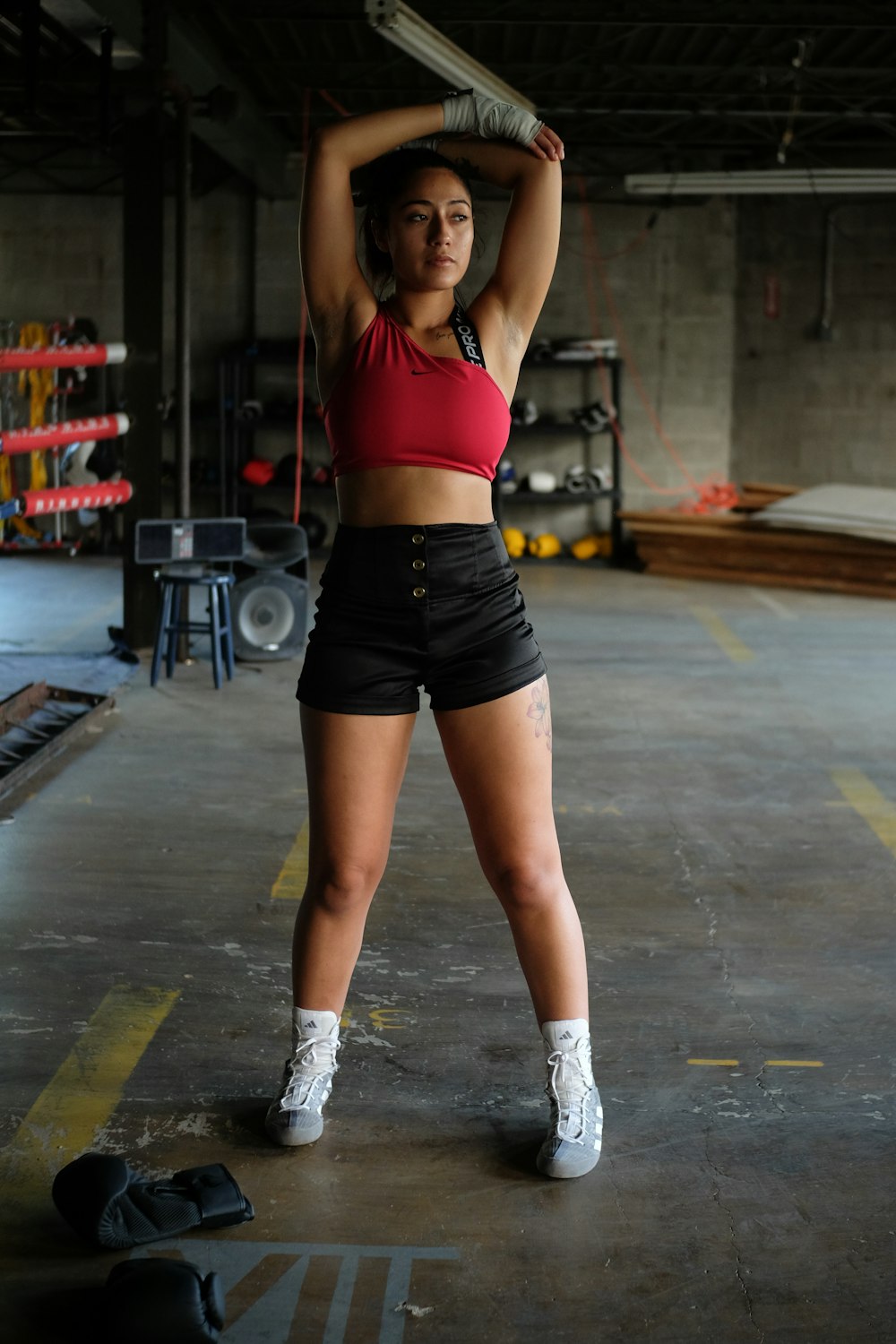 a woman holding a baseball bat in a garage