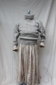 A stylish knitted sweater displayed on a mannequin.