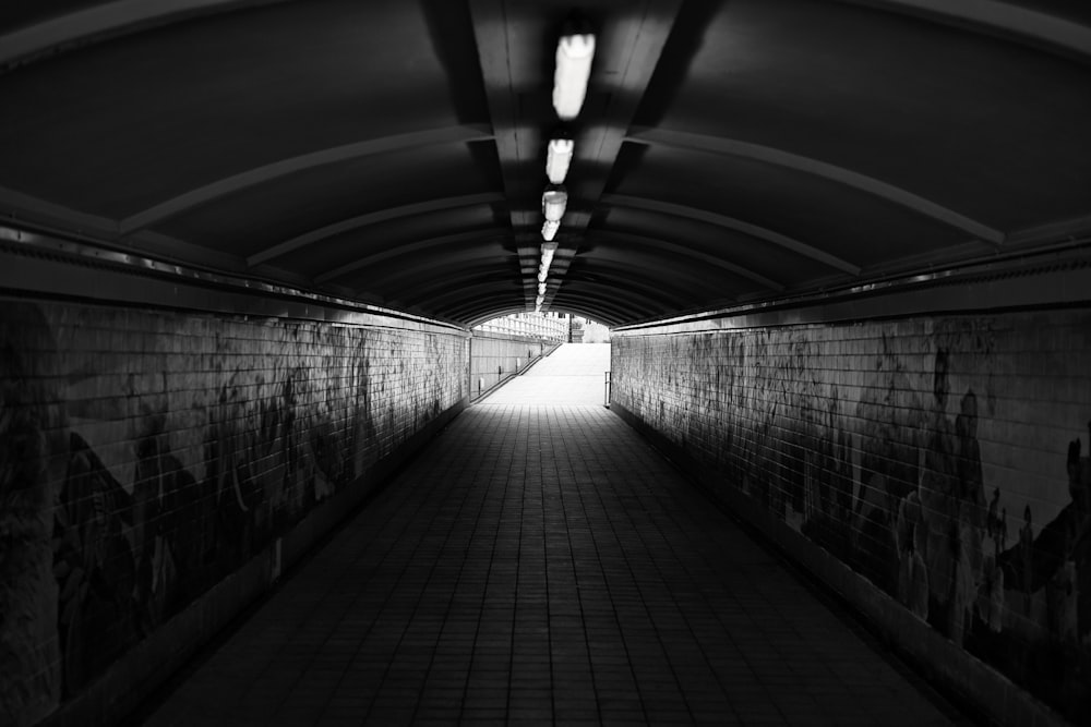 a black and white photo of a long tunnel