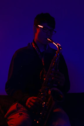Saxophonist lost in a soulful solo under warm stage lights.