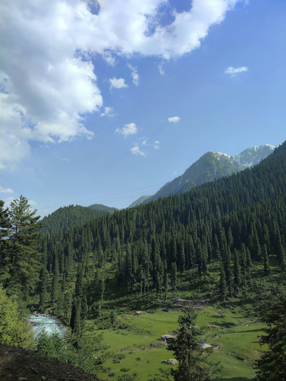 a scenic view of a mountain with a river running through it