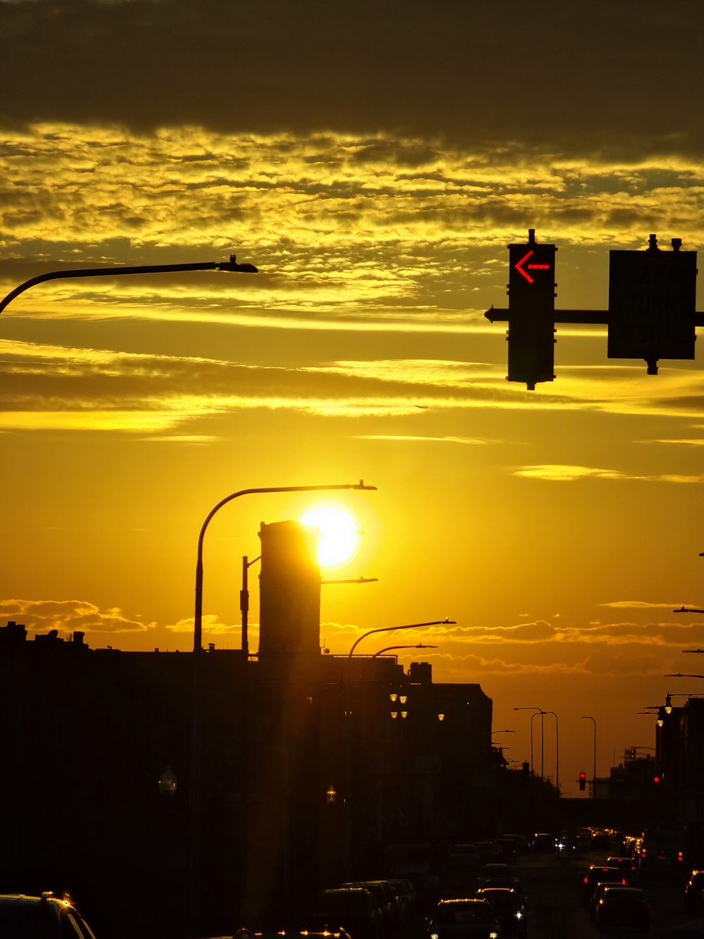 the sun is setting over a city street