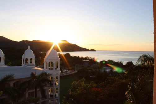 Scenic view of a coastal hotel in Messina at sunset.
