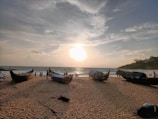 Sunset view over Singkawang beach with fishermen boats gently floating