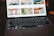 A smiling person viewing a vibrant photo gallery on a laptop screen.
