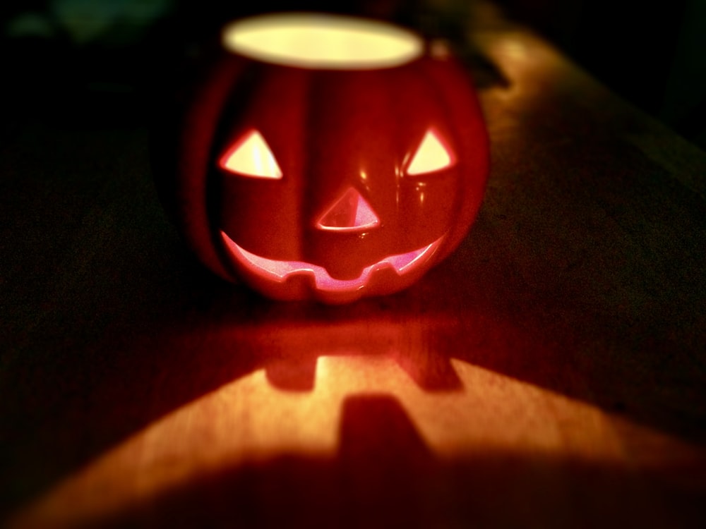 a lit up pumpkin sitting on top of a table