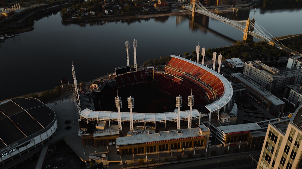 an aerial view of a stadium with a bridge in the background