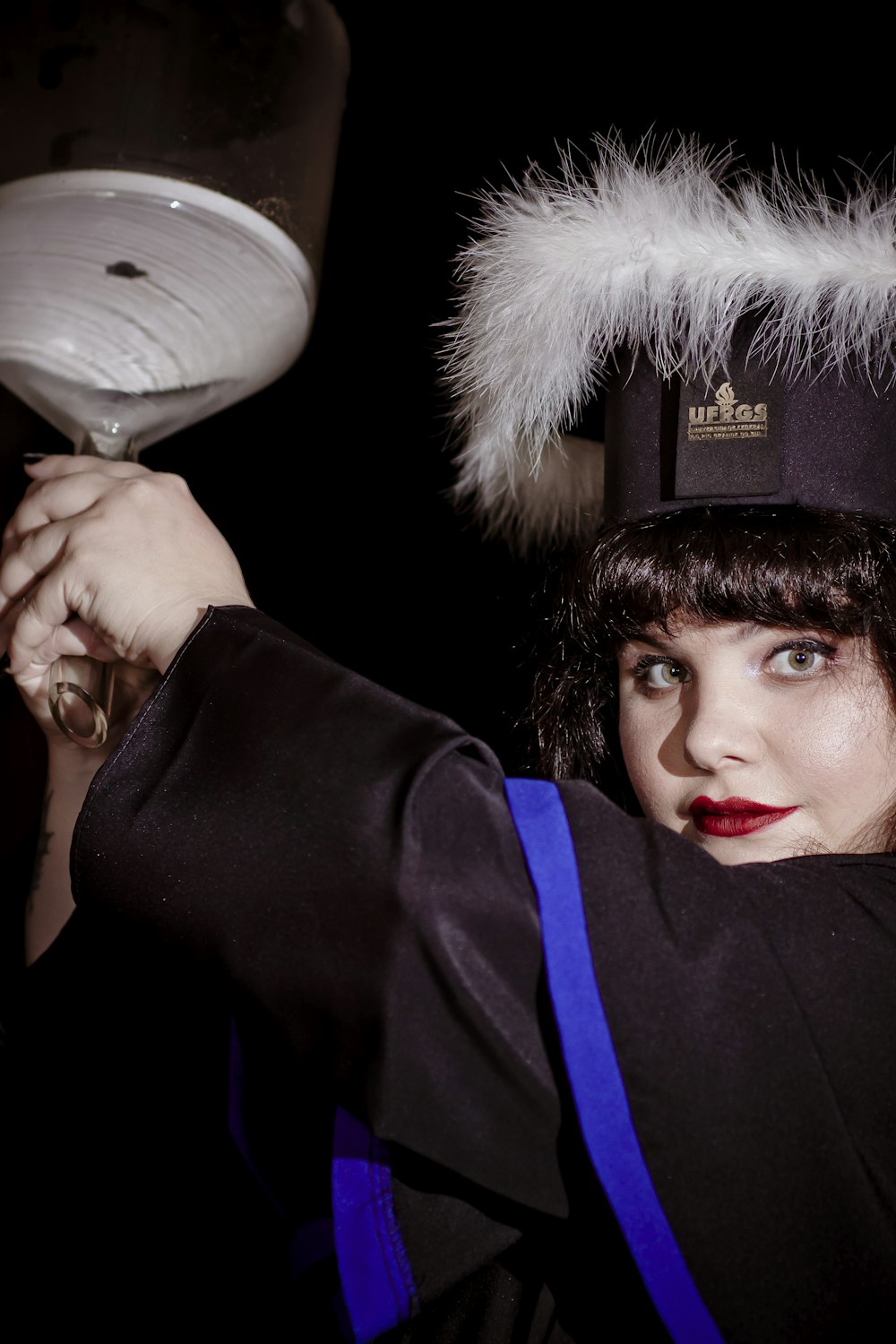 a woman in a costume holding a wine glass