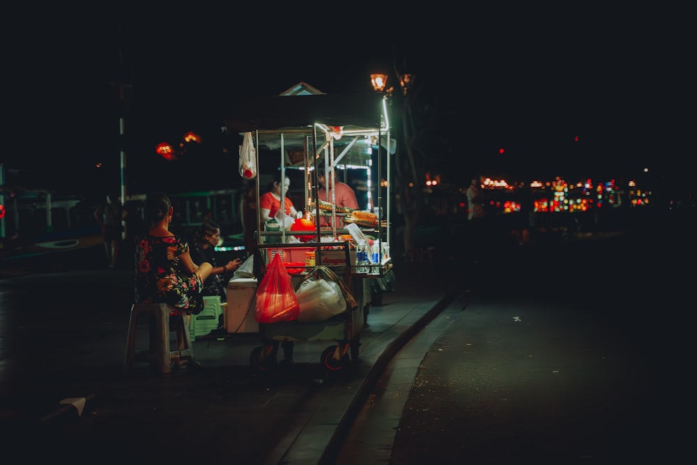 a food cart on the side of the road at night