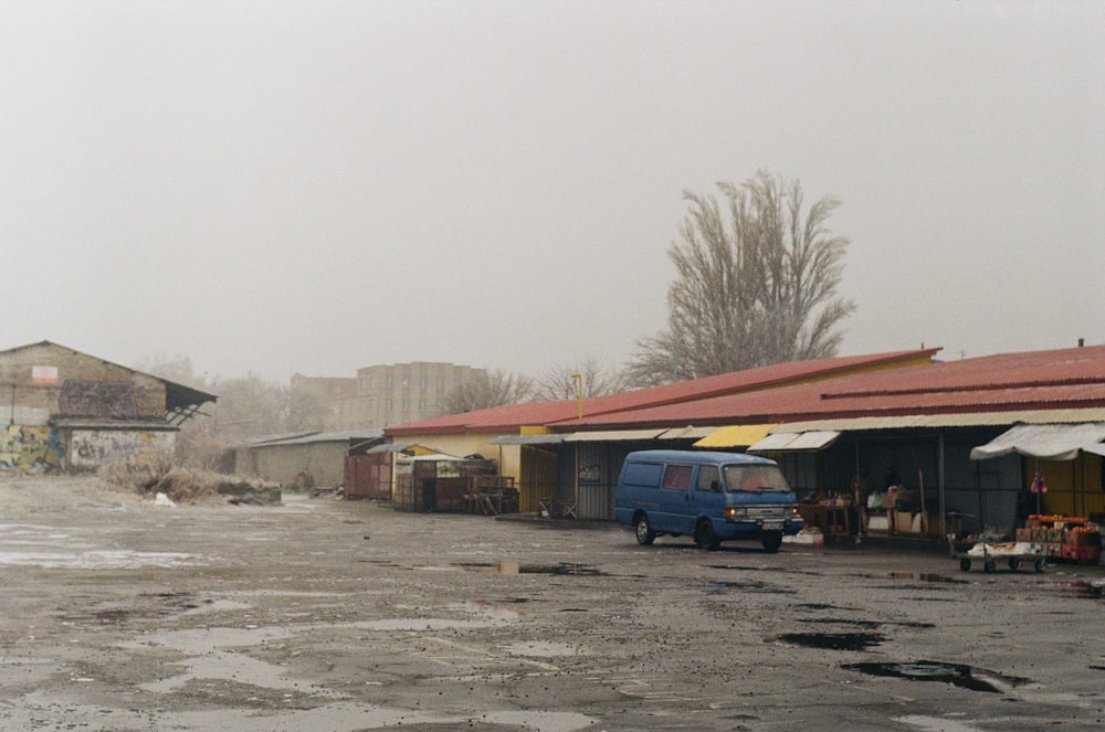 a parking lot with a van parked in front of it