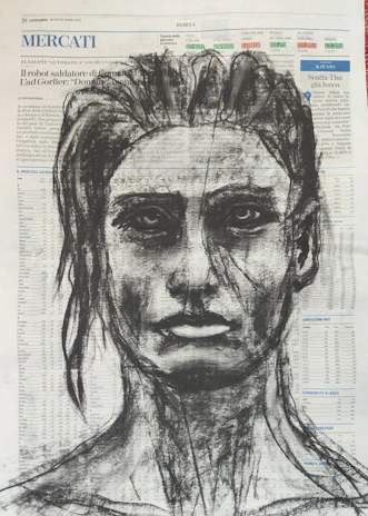 A close-up of a detailed charcoal sketch of a human face.