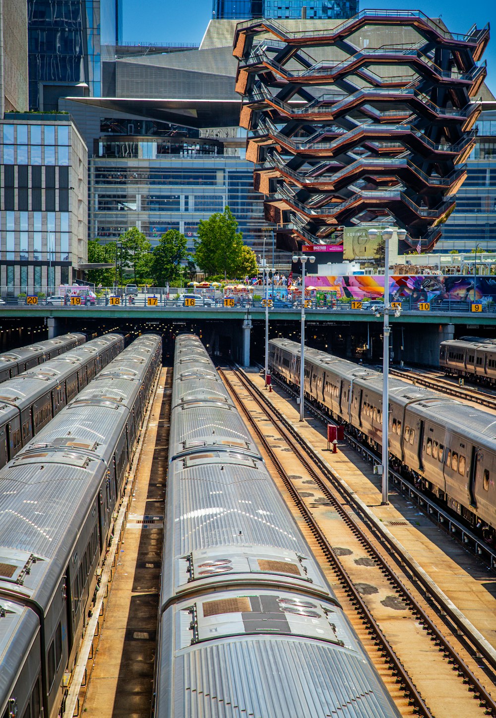 a train yard with several trains on the tracks