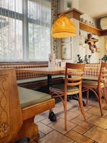 Cozy dining area with honeycomb shades adding warmth and energy efficiency.