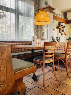 Elegant dining area with warm orange accents and cozy seating.