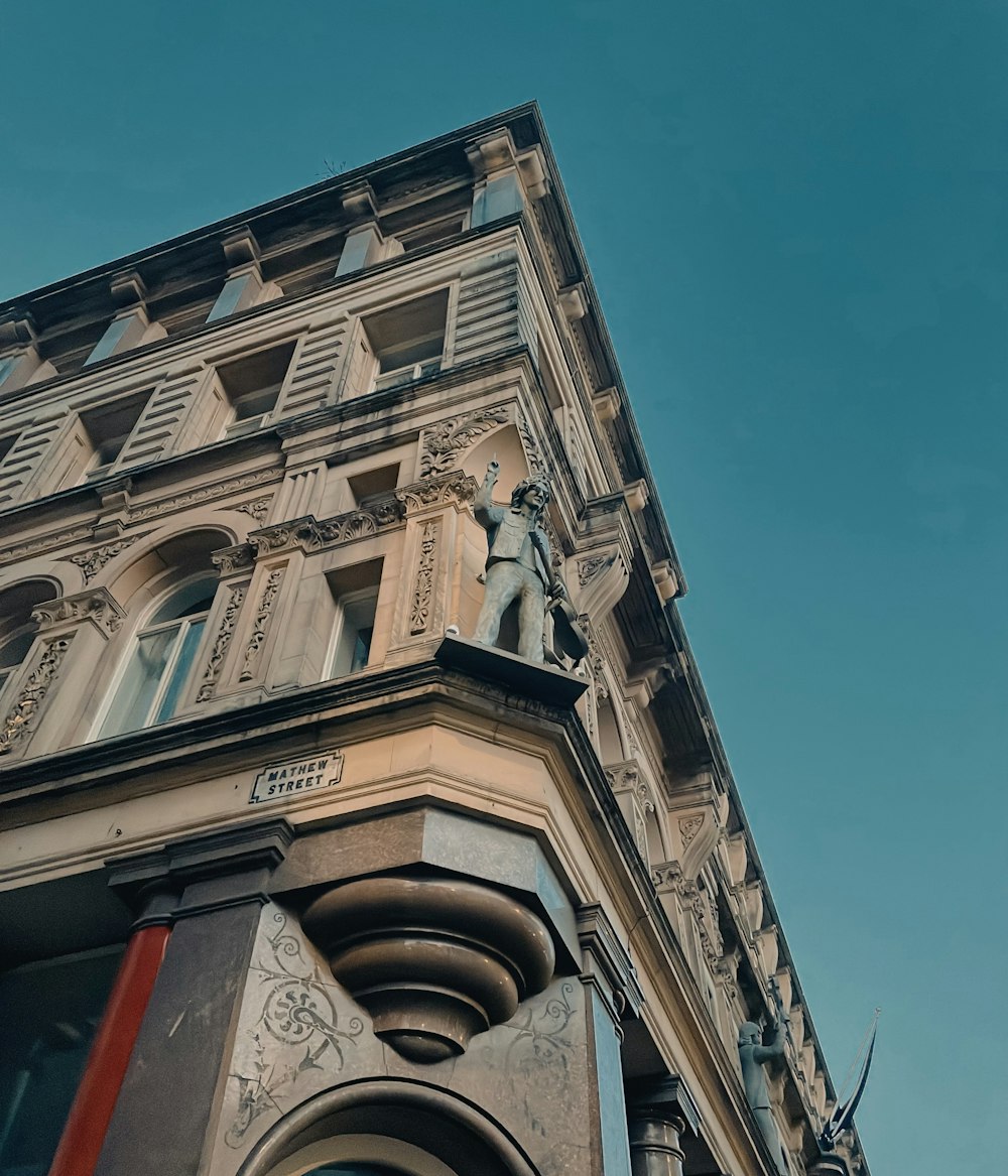 a tall building with a statue on top of it