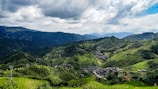 Panoramic view of rolling hills and ancient temples nestled in the heart of Ninh Binh countryside.