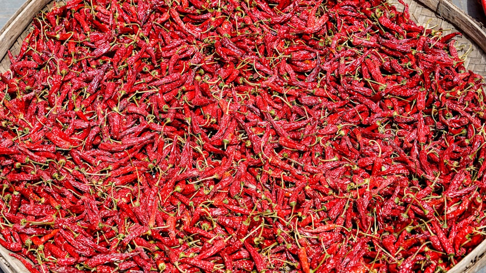 a basket filled with lots of red peppers