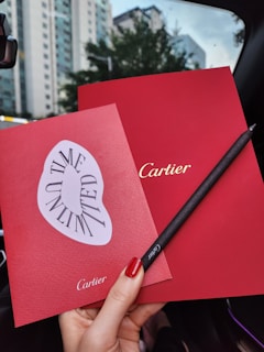Close-up of a chauffeur’s gloved hand handing over a welcome card to a client