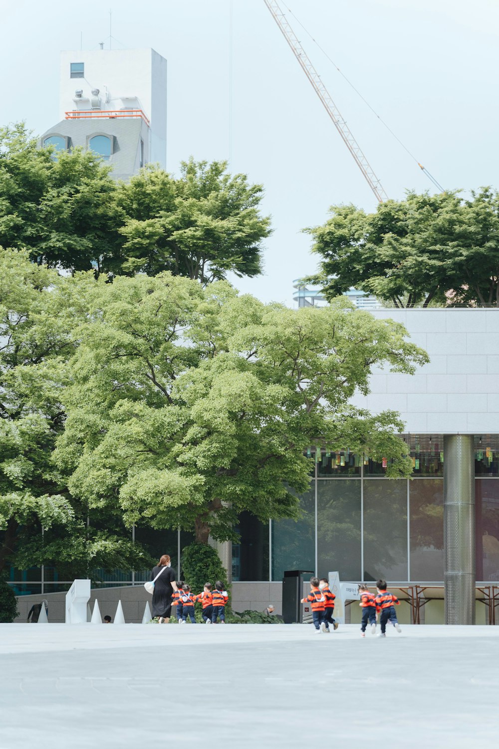 a group of people standing in front of a tall building