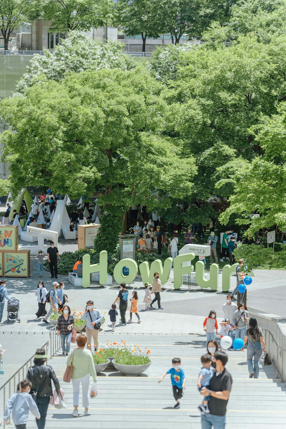 a crowd of people walking around a park