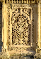Close-up of an intricately carved wooden panel featuring traditional Persian patterns.