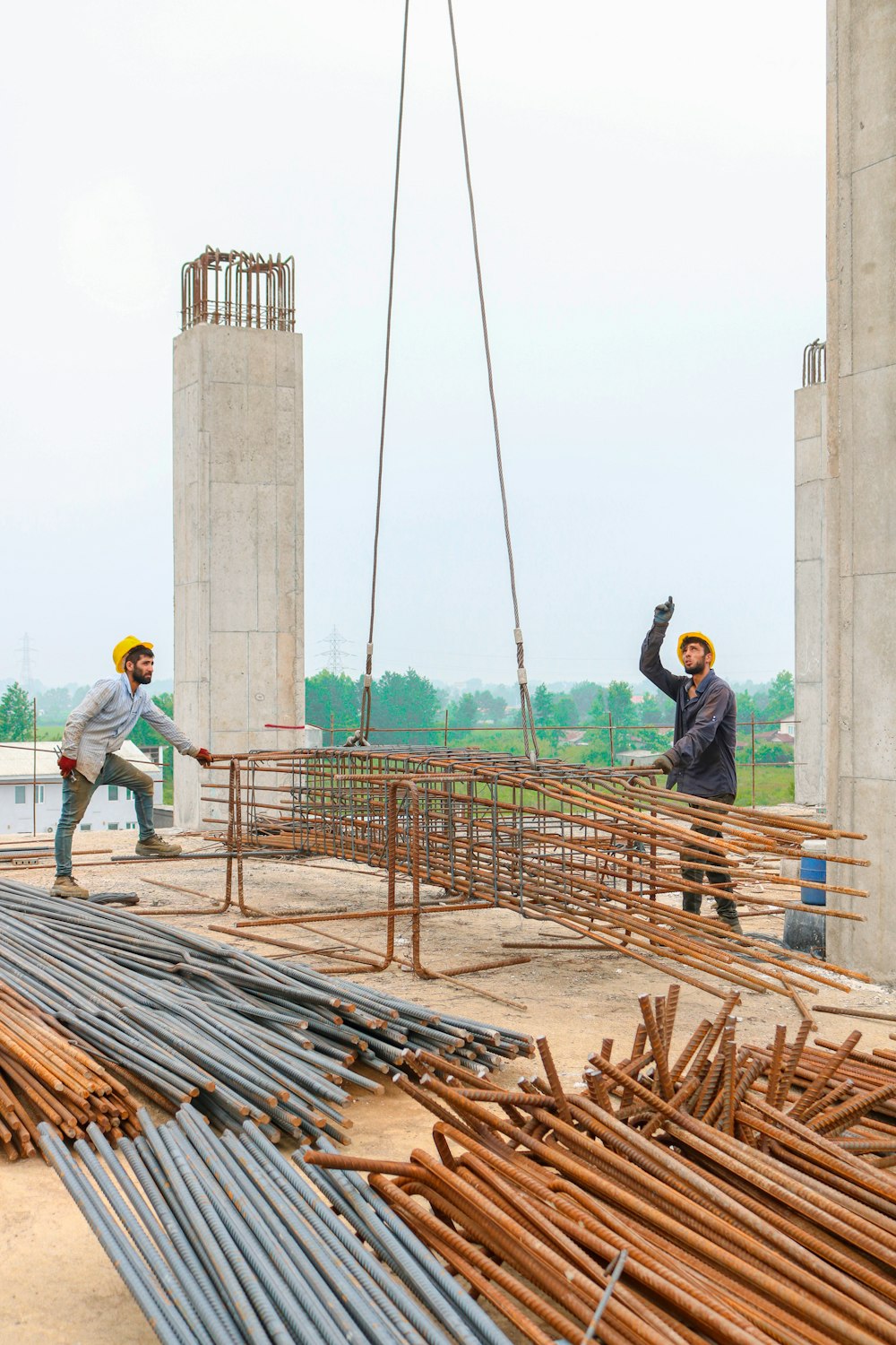 a couple of men standing on top of a construction site