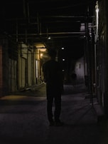 A shadowed alleyway at dusk, where two figures exchange a knowing glance.