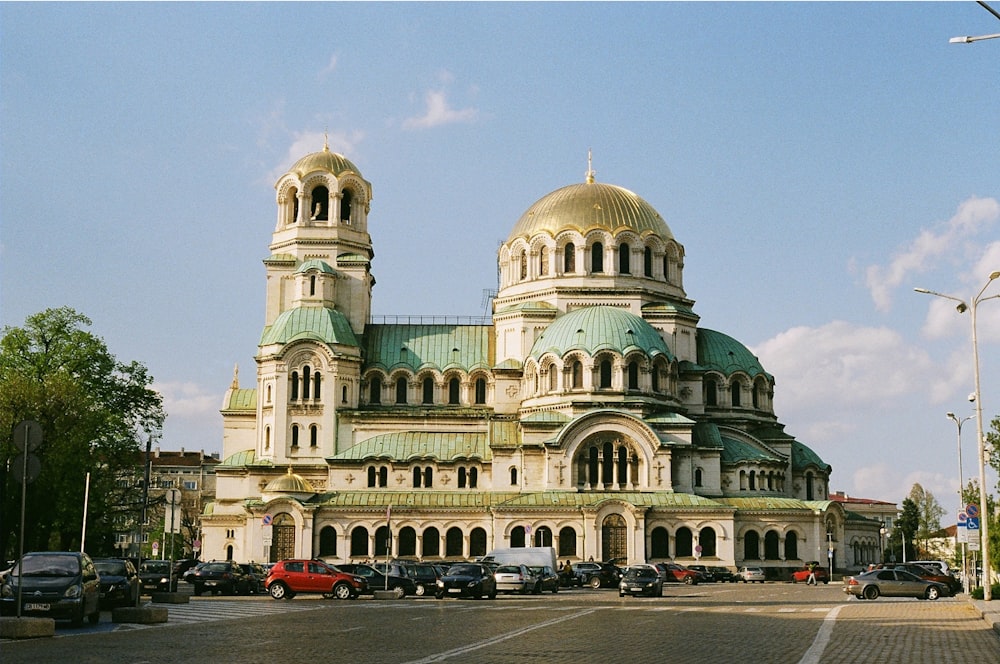 a large white building with a green roof