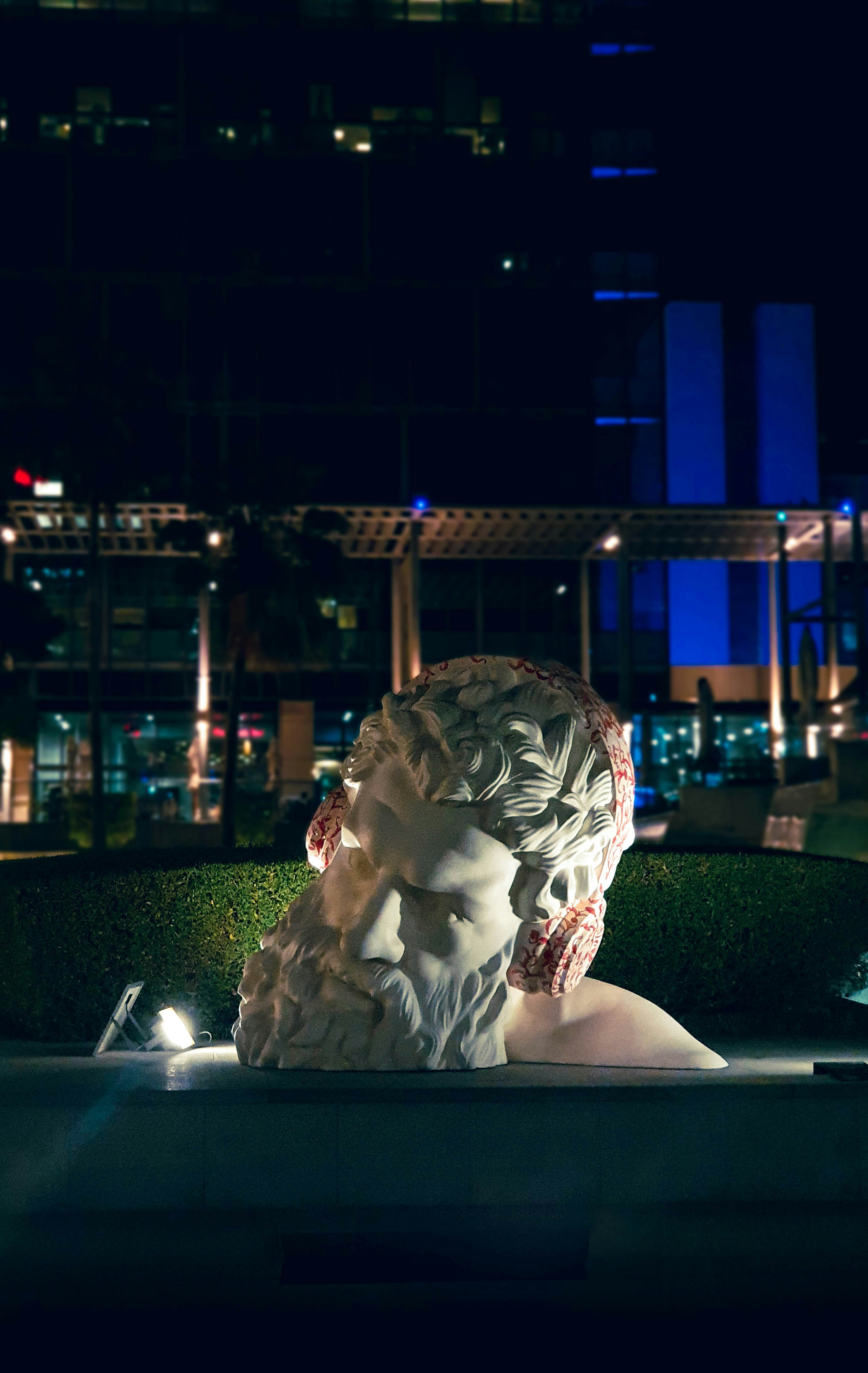 a statue of a woman in a park at night