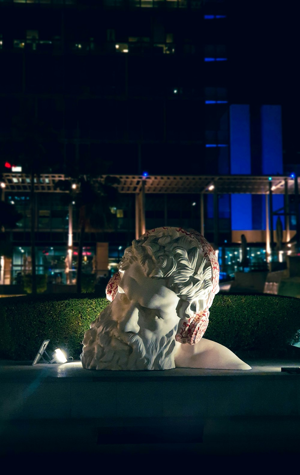 a statue of a woman in a park at night