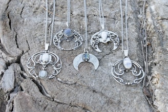 a group of necklaces sitting on top of a rock