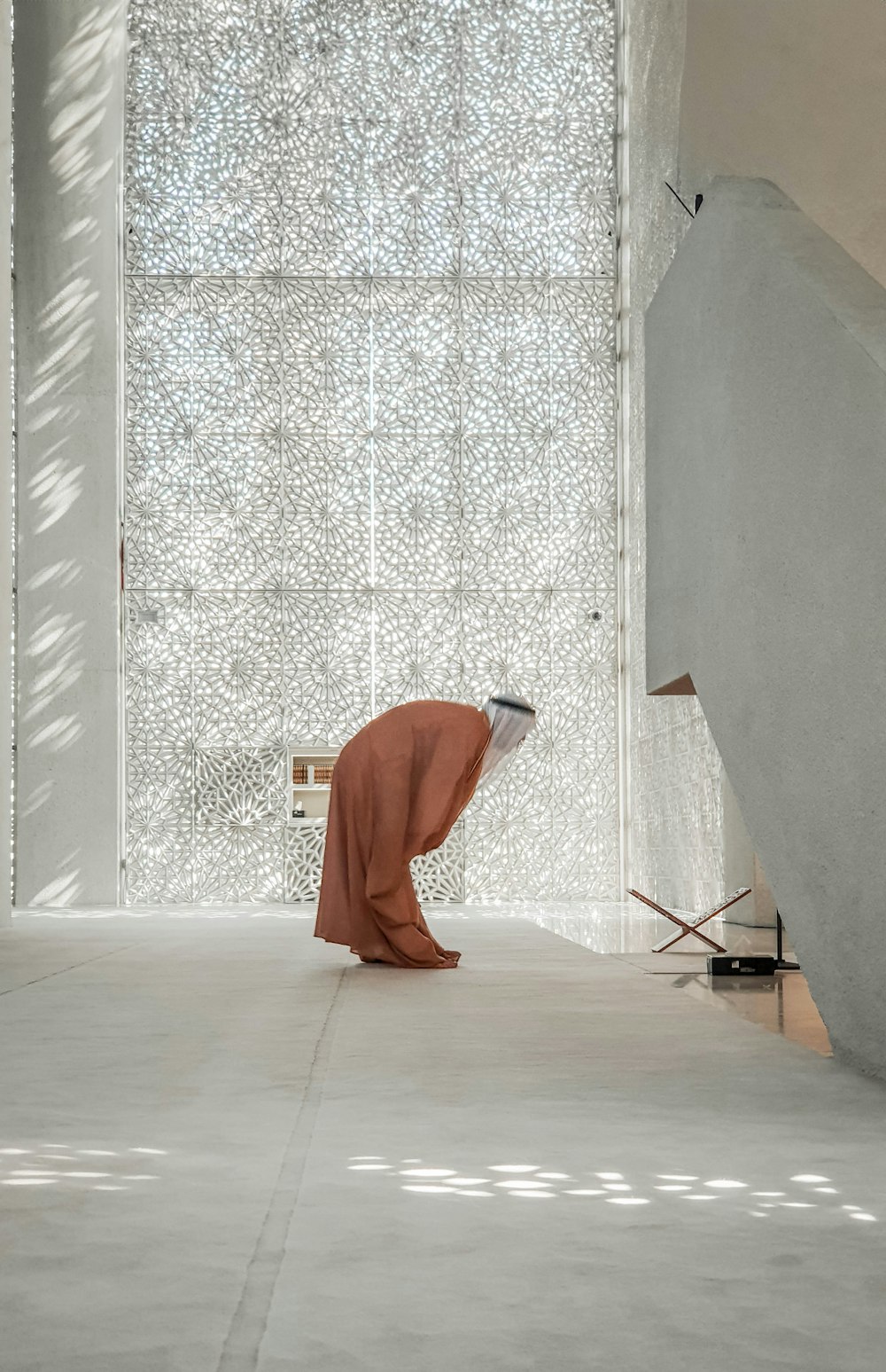 a person kneeling down in front of a wall