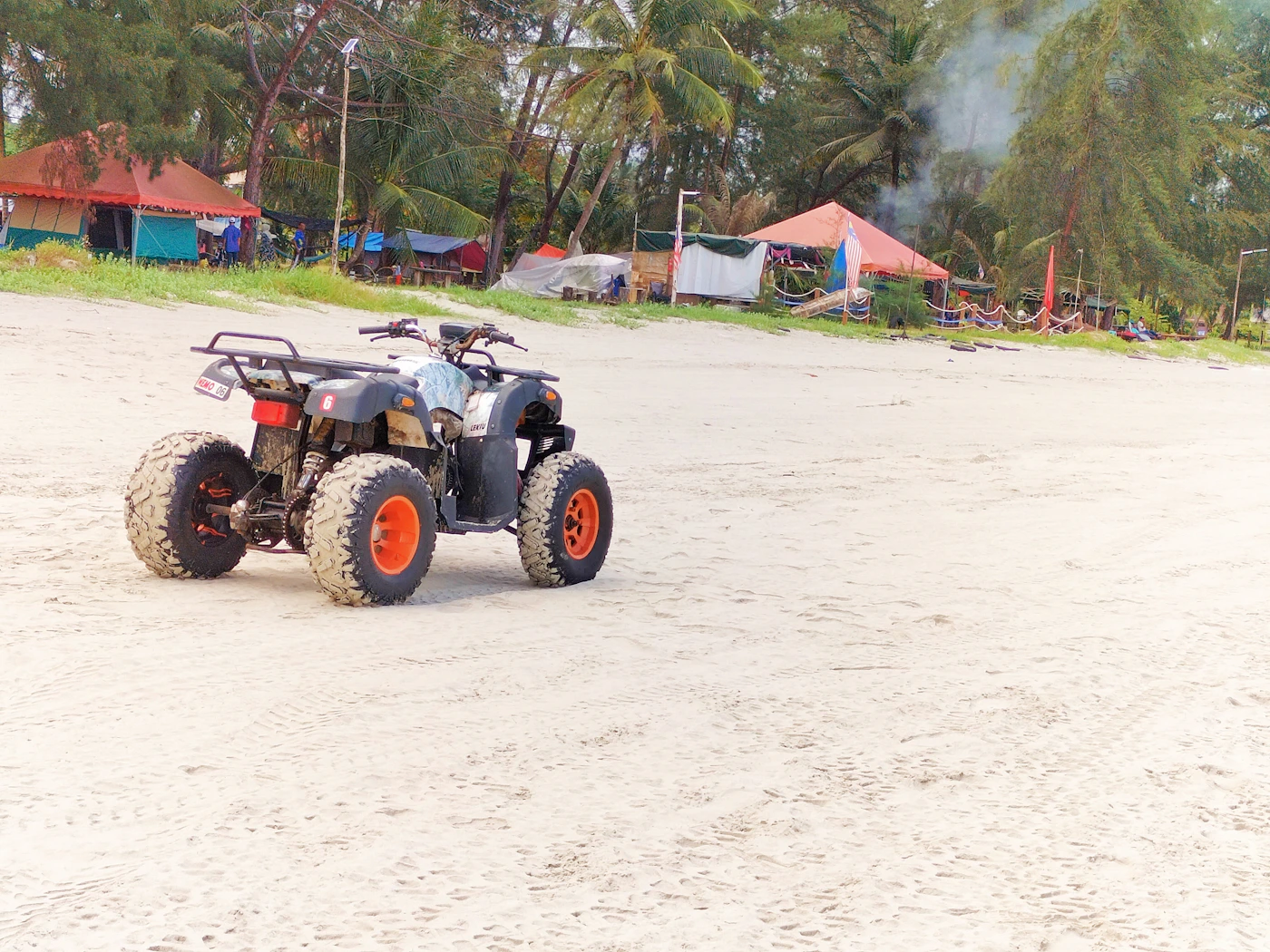 Off-road buggy moving through a muddy tropical track