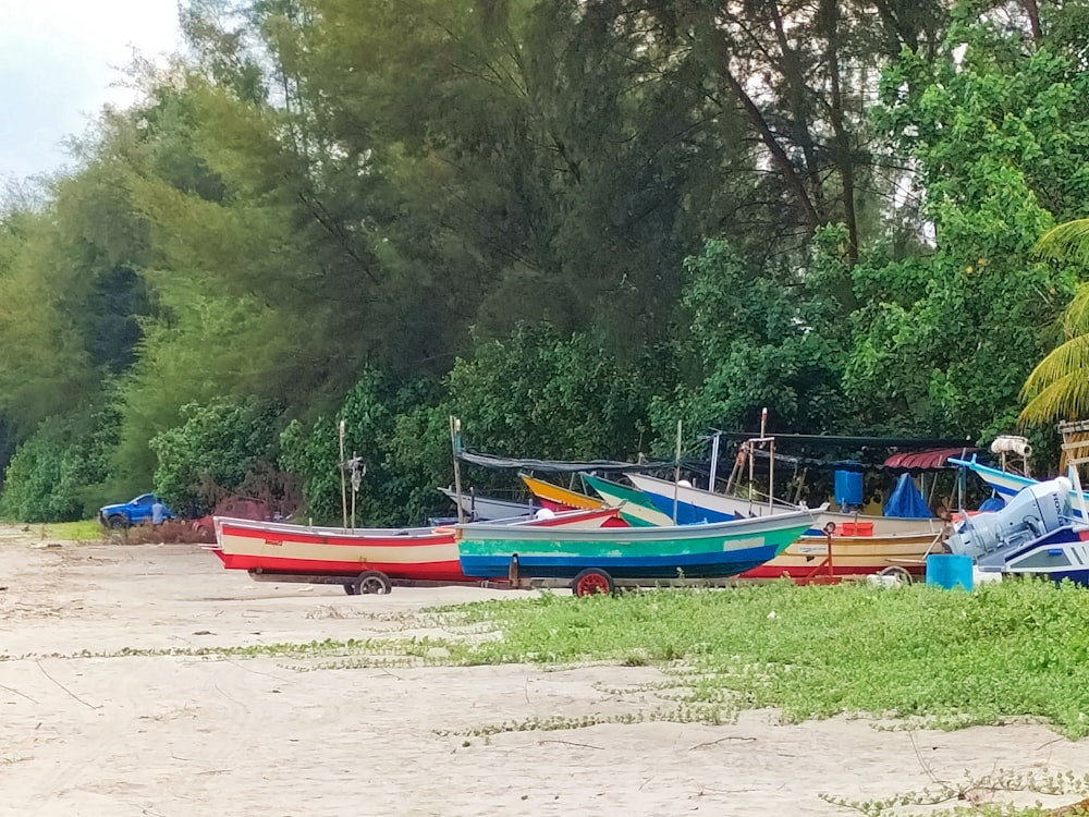 a group of boats sitting on top of a sandy beach